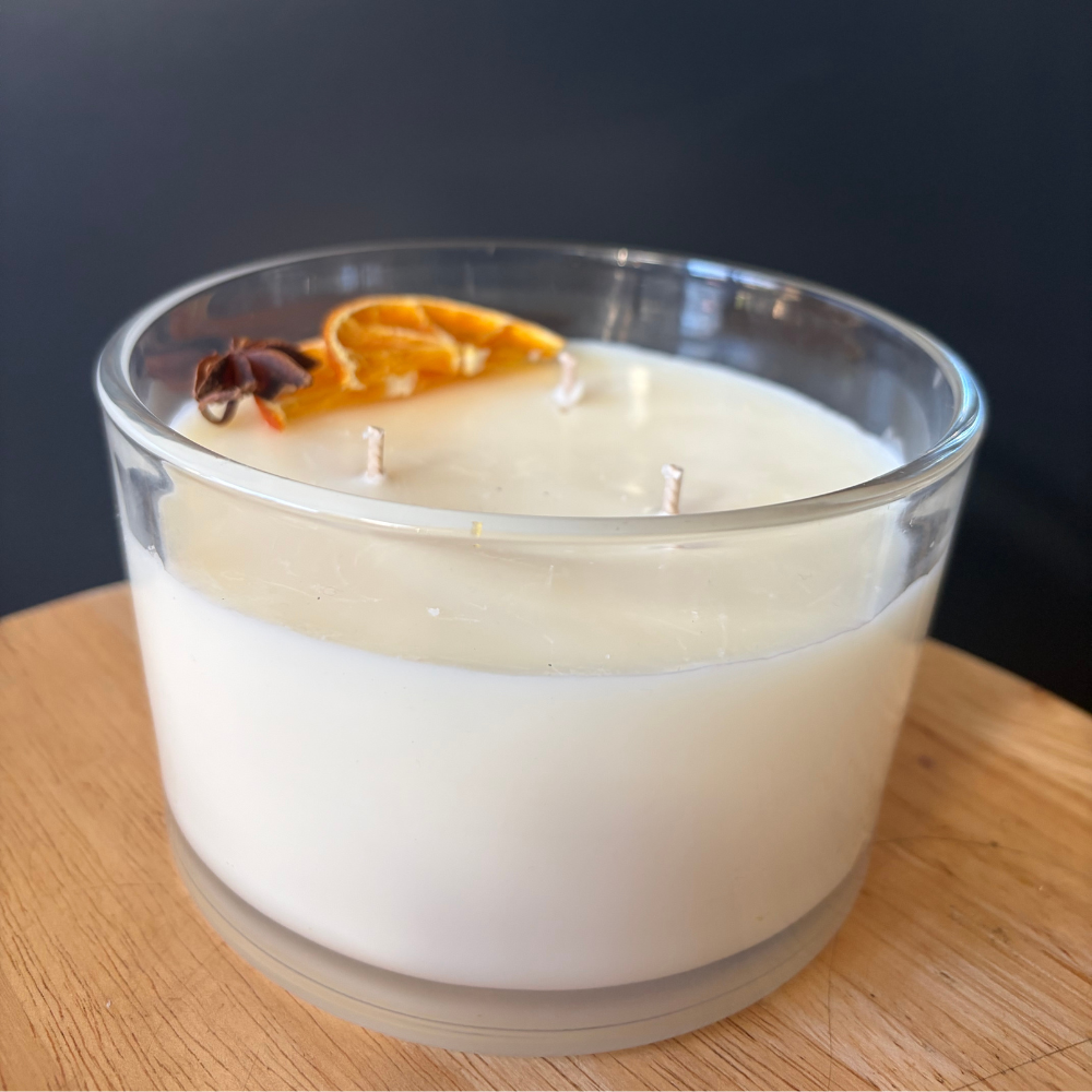 natural soya wax candle in a glass jar with orange peel and star anise